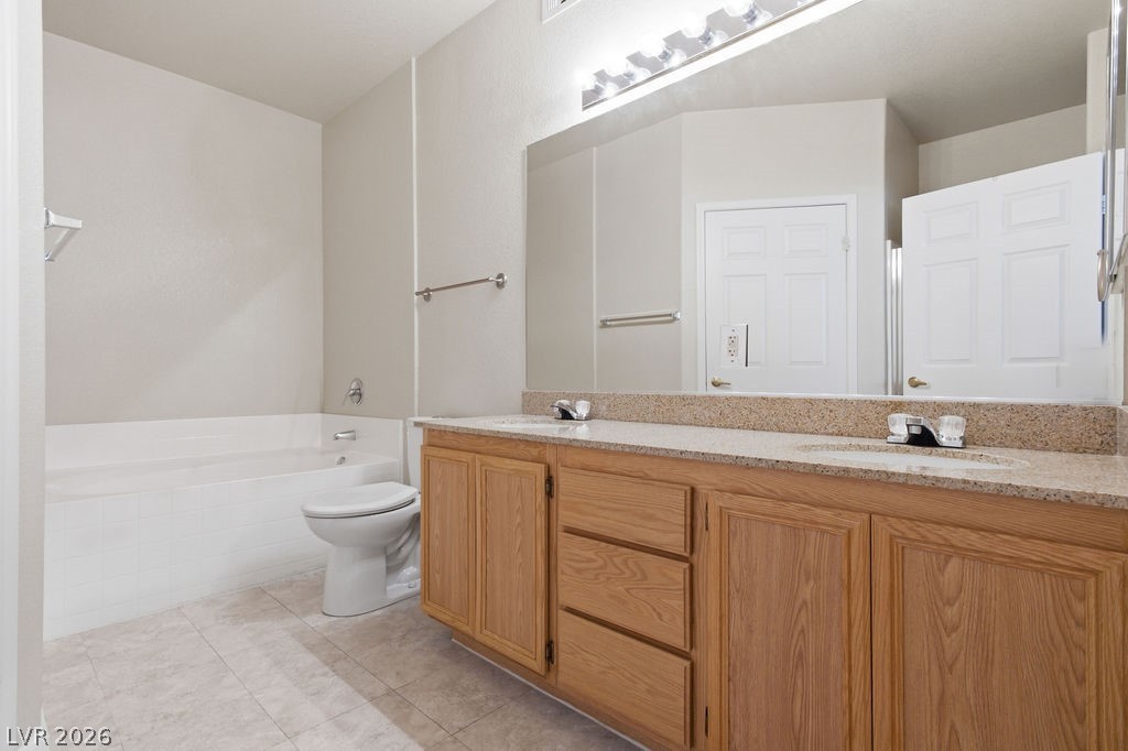 10550 West Alexander Road, Unit 2133 Las Vegas, NV 89129 - Photo 30 of 42 This bathroom features a double vanity with granite counters and a spacious soaking tub.