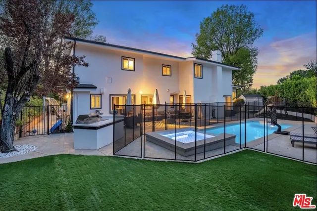 a view of a backyard with a garden and sitting area