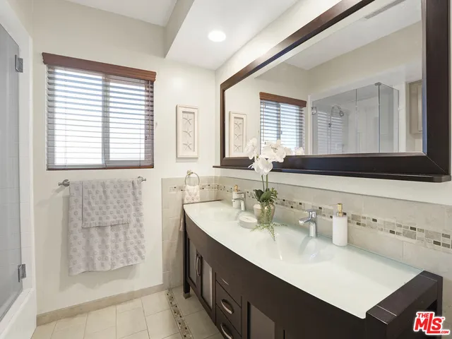 a bathroom with a sink double vanity and a shower