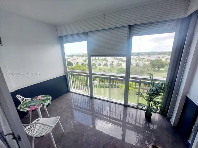 a view of a porch with furniture and a yard