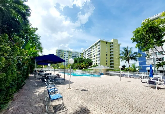 a view of a patio with a table and chairs under an umbrella