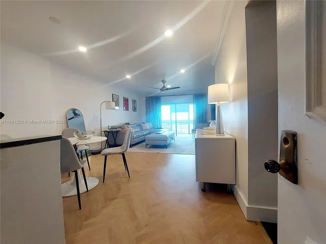 a living room with furniture a lamp and a window