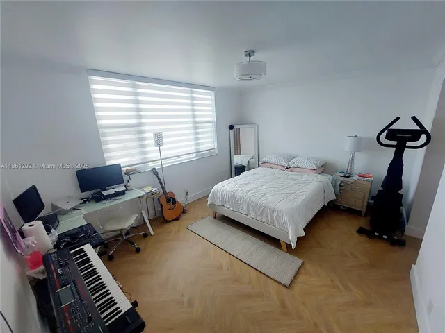 a bedroom with bed and window