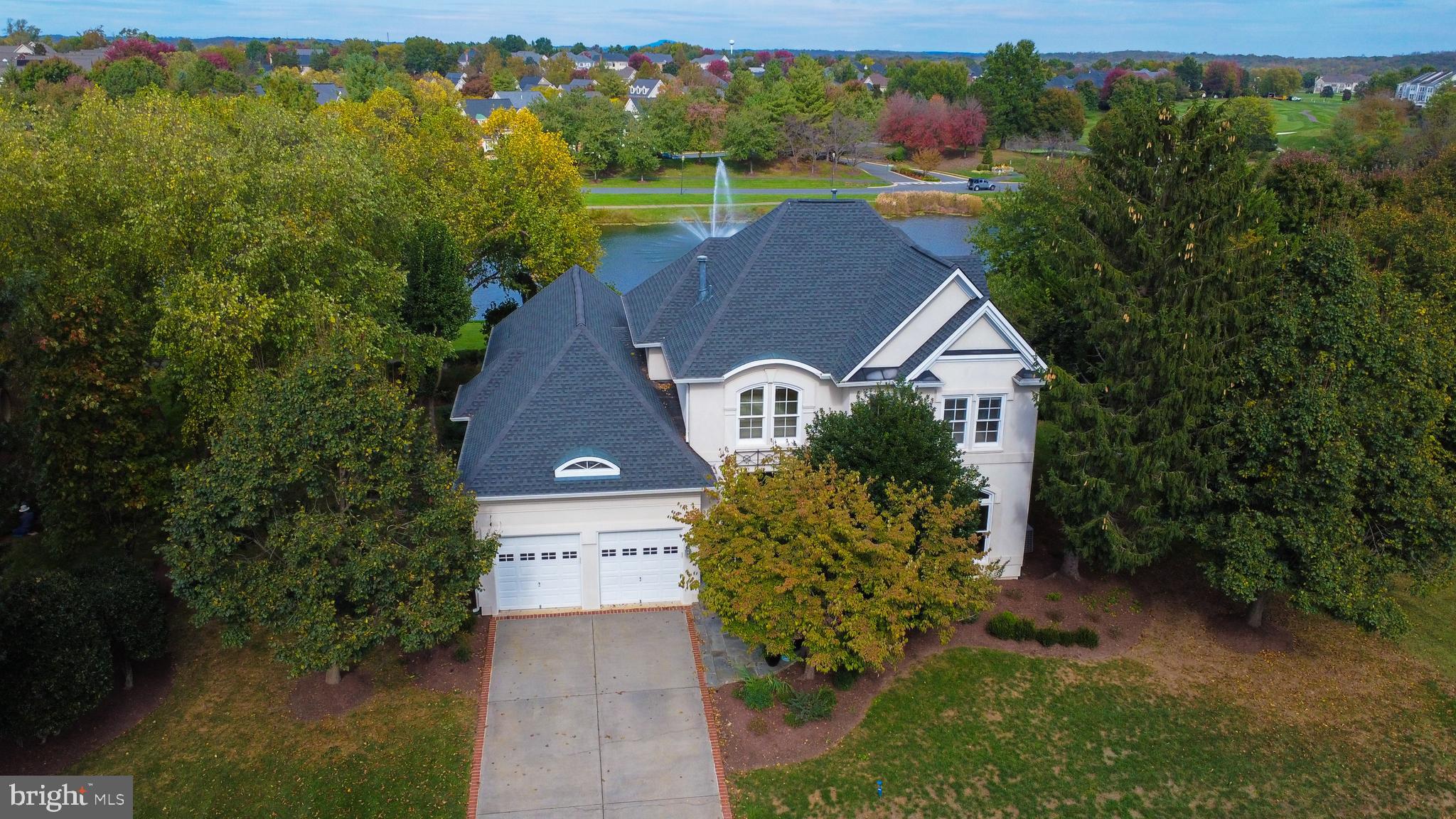 an aerial view of a house with a yard and lake view