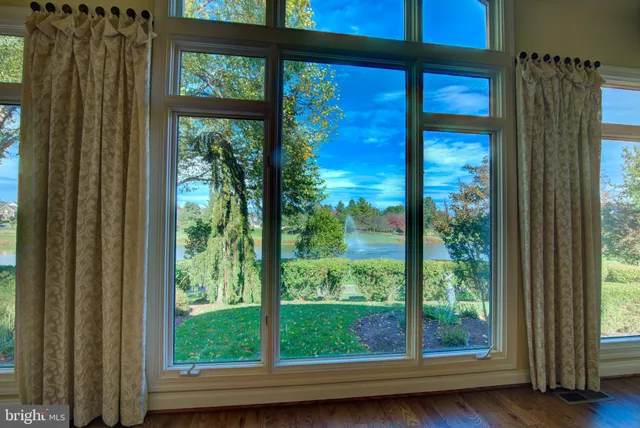 a view of an empty room with a fireplace and a window
