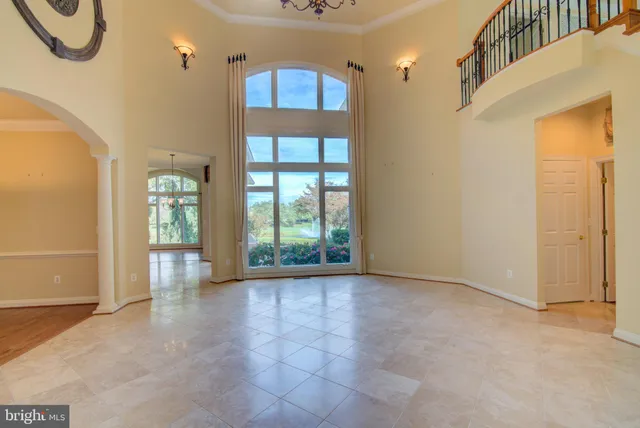 a view of an entrance with wooden floor and windows