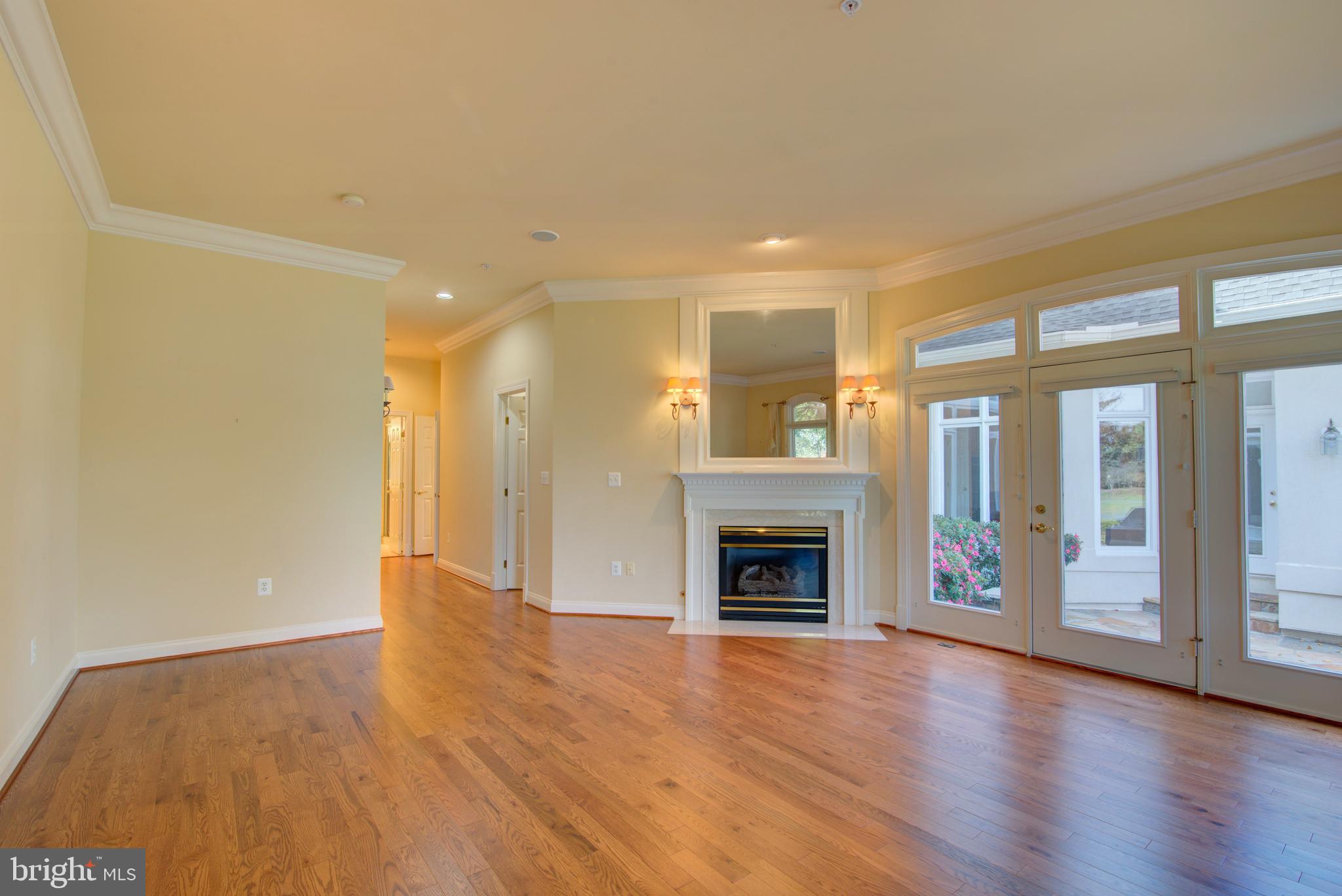 43462 Firestone Place Leesburg, VA 20176 - Photo 26 of 80 a view of an empty room with a fireplace and a window
