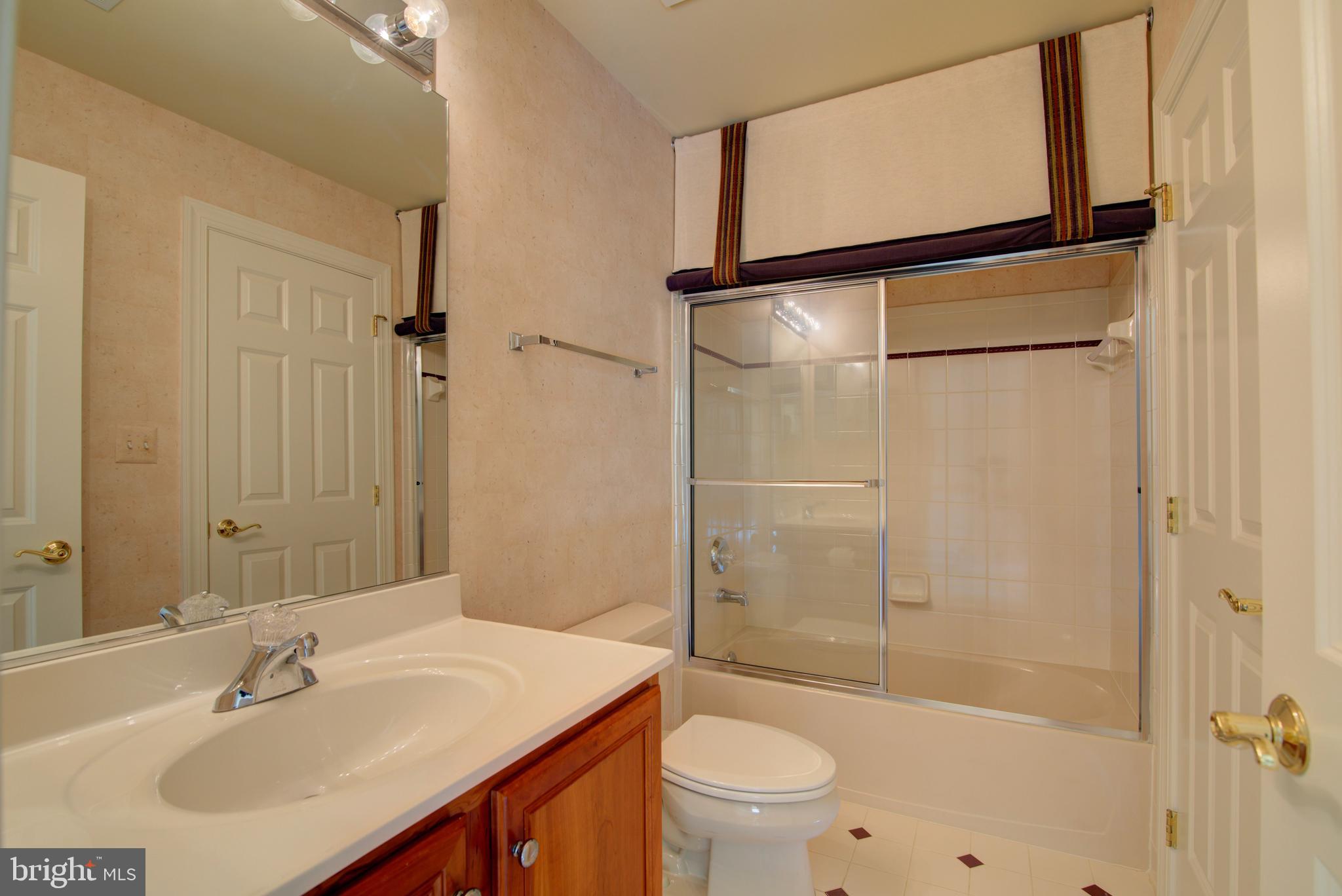 43462 Firestone Place Leesburg, VA 20176 - Photo 36 of 80 a bathroom with a sink toilet and shower