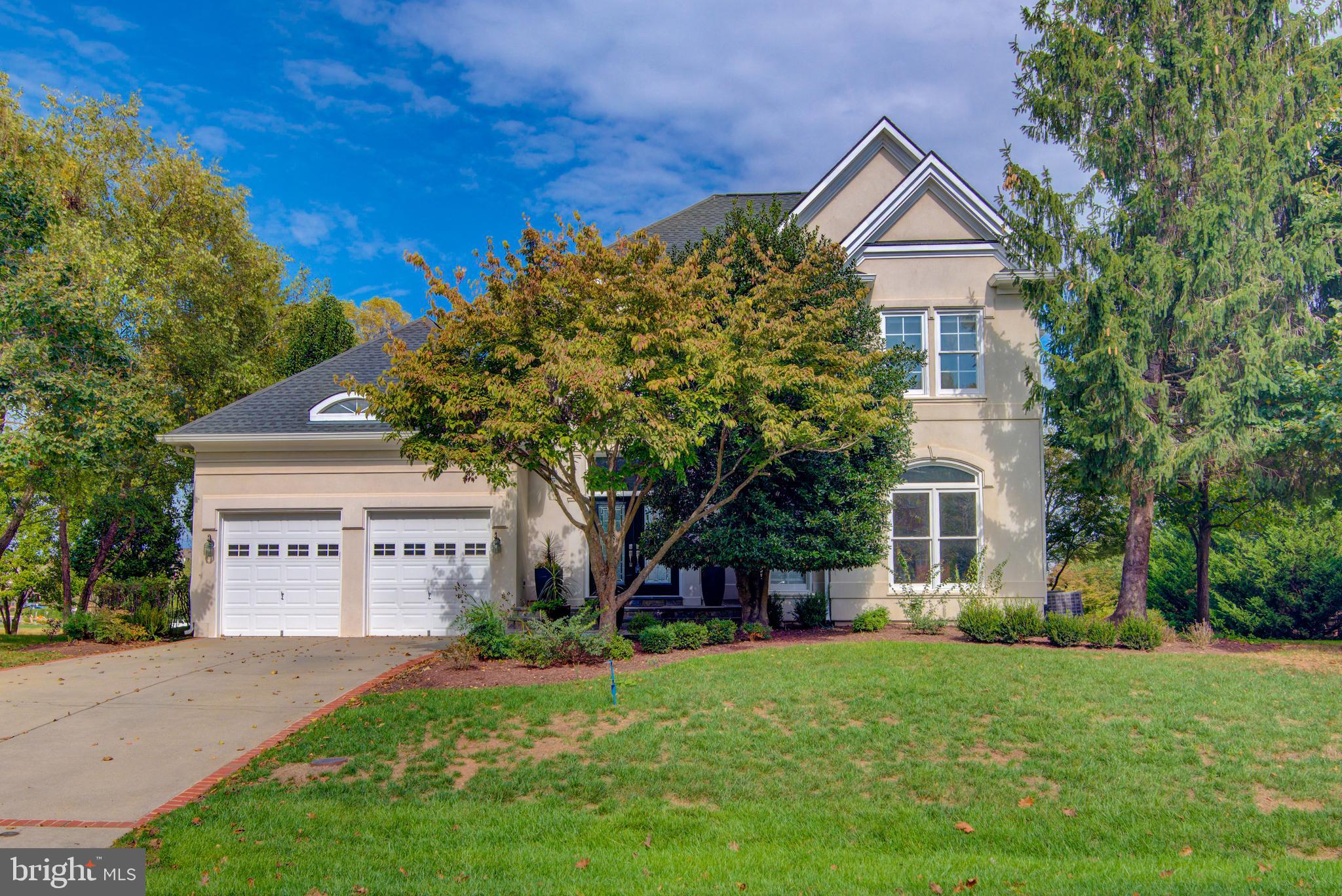 43462 Firestone Place Leesburg, VA 20176 - Photo 4 of 80 a front view of a house with a yard and garage