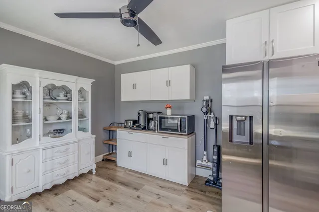 a kitchen with stainless steel appliances a refrigerator sink and cabinets