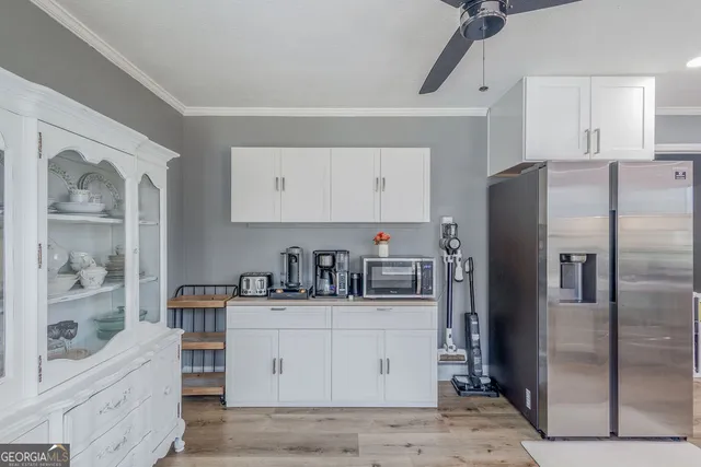 a kitchen with stainless steel appliances a refrigerator sink and cabinets