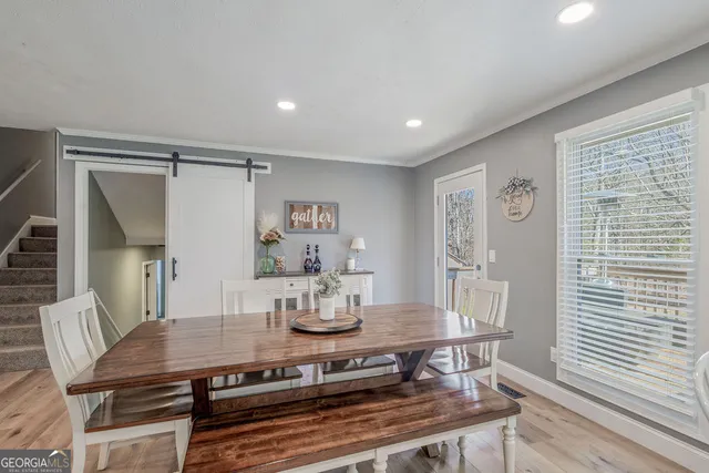 a view of a dining room with furniture and wooden floor