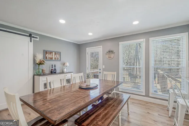 a view of a dining room with furniture window and wooden floor