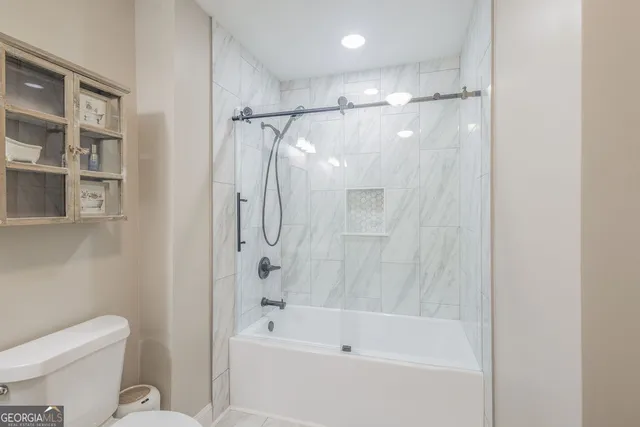 a bathroom with a shower a toilet and a shower