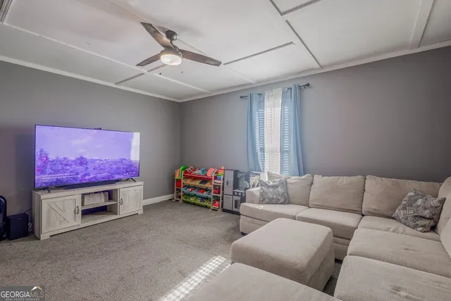 a living room with furniture and a flat screen tv
