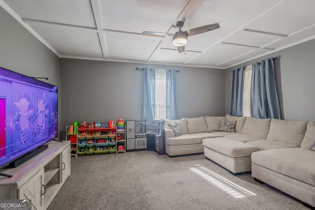 a living room with furniture a baby crib furniture and a window