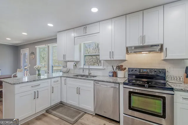 a kitchen with a sink stove and cabinets
