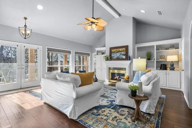 a living room with furniture fireplace and a large window