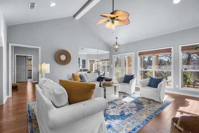 a view of a dining room with furniture a chandelier and wooden floor