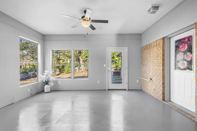 a view of a livingroom with furniture and a window