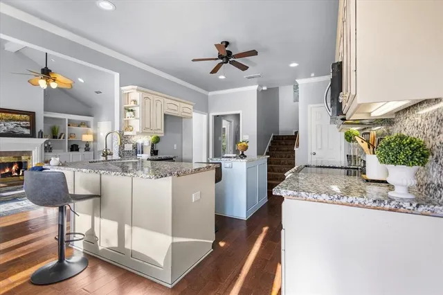 a kitchen with stainless steel appliances granite countertop a sink and cabinets