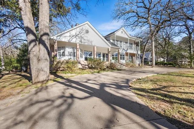a view of a white house with a yard covered with snow