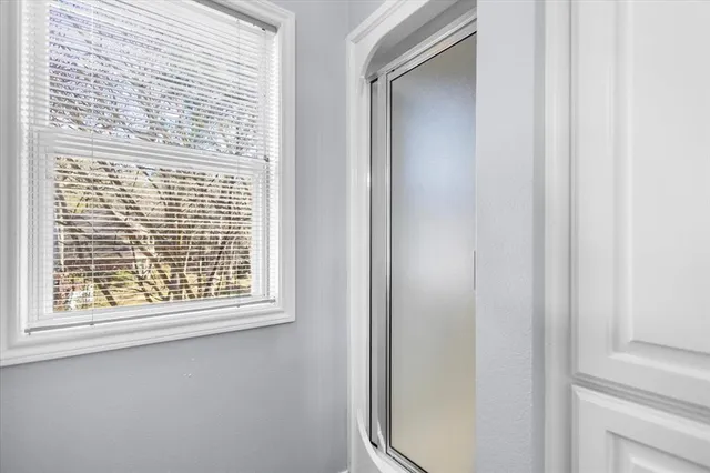 a view of a hallway with wooden floor and a bedroom