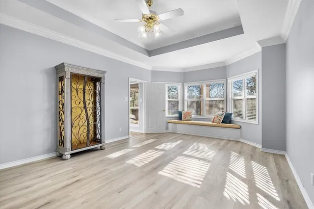 a spacious bedroom with a bed and a chandelier