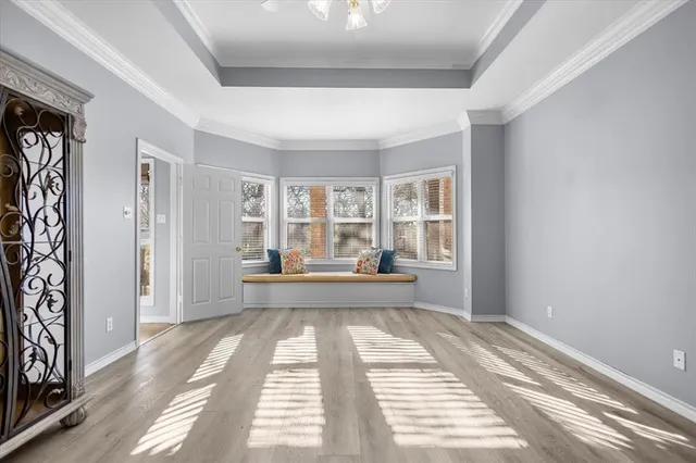 a view of a bedroom with wooden floor and furniture