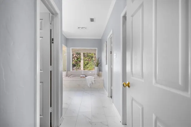 a view of entryway with bathroom and shower