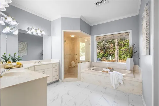 a spacious bathroom with a tub sink and mirror