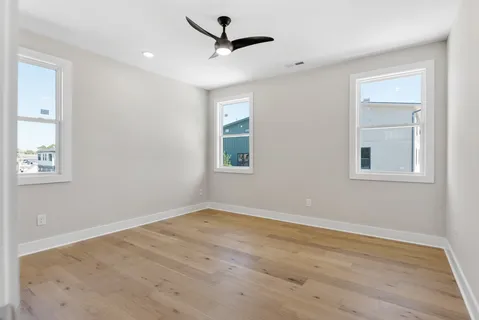 a living room with furniture and paintings on the wall