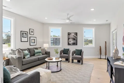 a living room with furniture and paintings on the wall