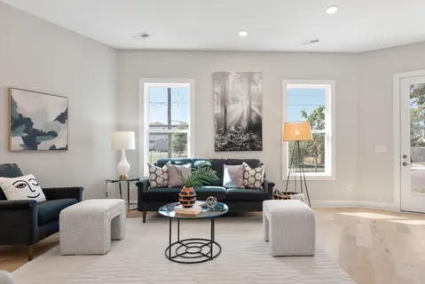 a living room with furniture and a lamp