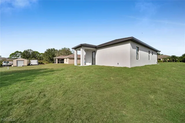 a big house with a big yard and more large trees