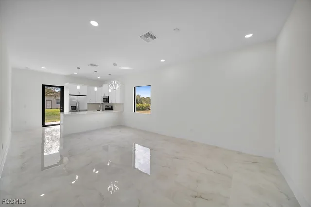 a view of a kitchen with a sink and a refrigerator