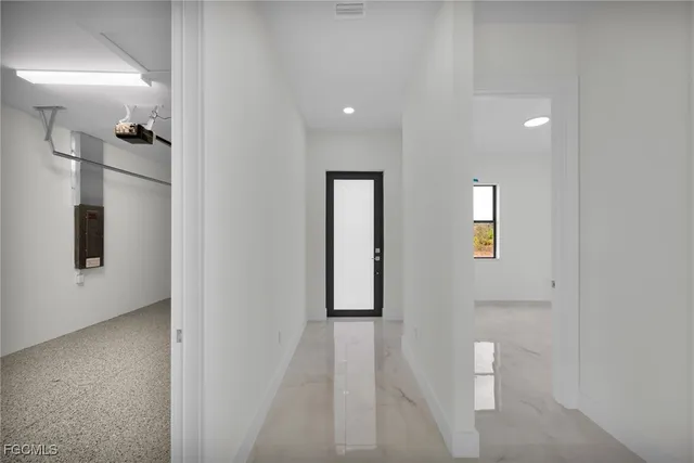 a view of a hallway with windows and closet