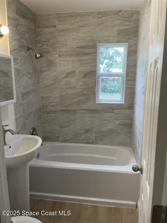 a bath tub sitting next to a white toilet