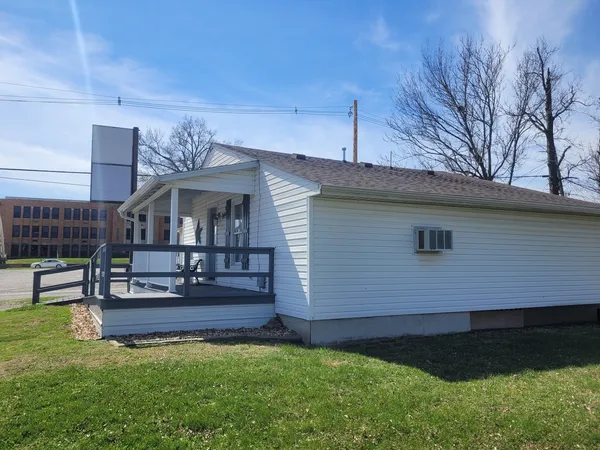 a front view of house with yard and outdoor seating