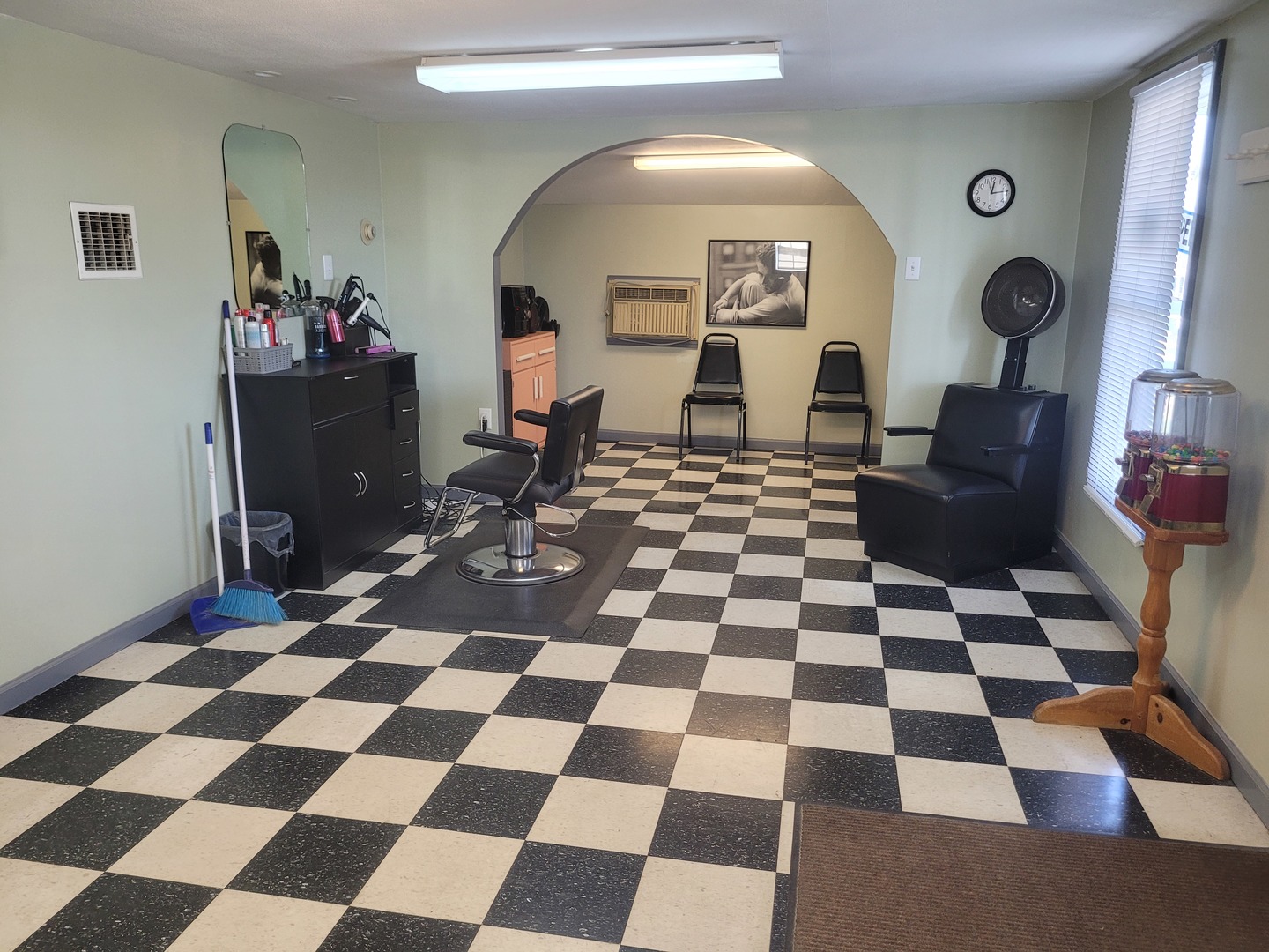 105 18th Street Mount Vernon, IL 62864 - Photo 7 of 16 a living room with a black white checkered floor with a gaming machine and dining chairs