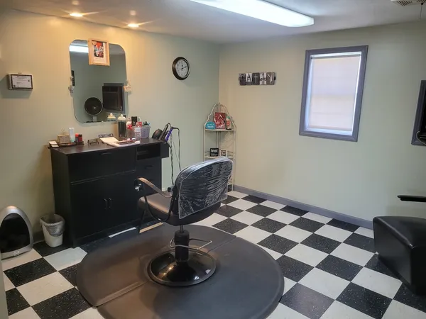 a living room with a black white checkered floor with couches and a coffee table