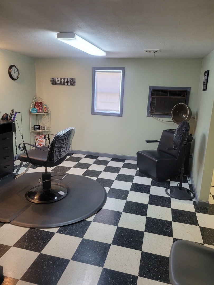 105 18th Street Mount Vernon, IL 62864 - Photo 10 of 16 a living room with a black white checkered floor with a gaming machine and dining chairs