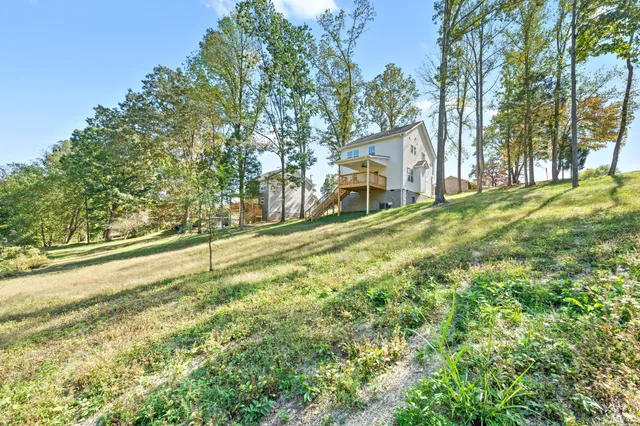 a view of a house with a yard and sitting area
