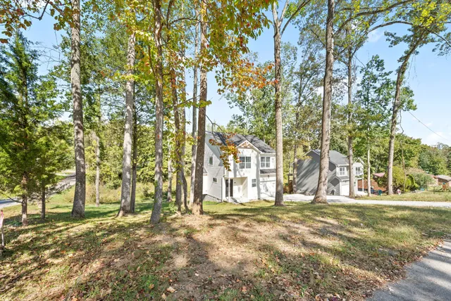 a view of a house with backyard and a porch