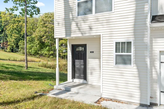 a view of a hallway with wooden floor and entryway