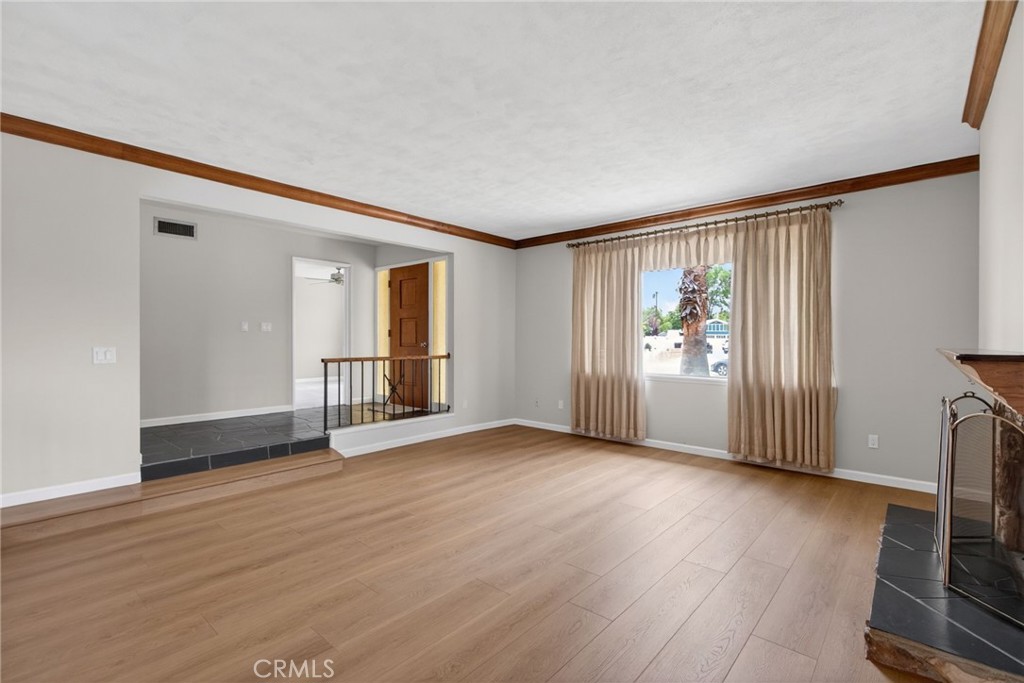 4963 Carlingford Avenue Riverside, CA 92504 - Photo 2 of 33 a view of an empty room with wooden floor and a window