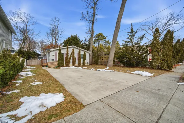 a view of a house with snow on the road