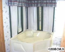 860 Mclendon Road Morven, NC 28119 - Photo 1 of 4 a bathroom with bathtub and shower