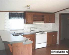 860 Mclendon Road Morven, NC 28119 - Photo 3 of 4 a kitchen with stainless steel appliances granite countertop a sink stove and refrigerator