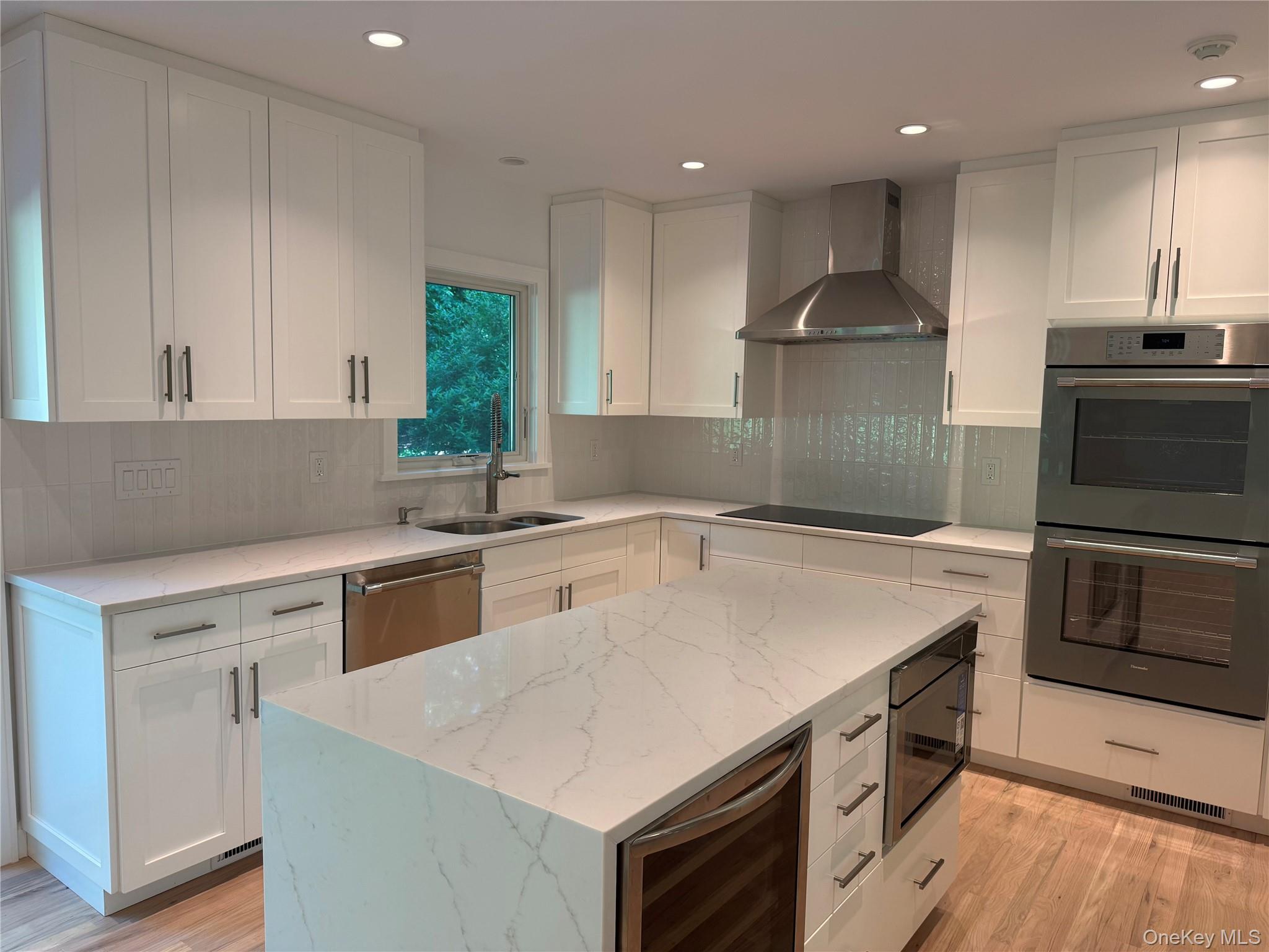24 Country Road Mamaroneck, NY 10543 - Photo 8 of 37 a kitchen with a stove a sink and a microwave